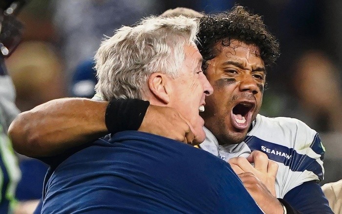 Seattle Seahawks head coach Pete Carroll, left, celebrates with quarterback Russell Wilson after the Seahawks defeated the San Francisco 49ers 27-24 in overtime of an NFL football game in Santa Clara, Calif., Monday, Nov. 11, 2019. (AP Photo/Tony Avelar) Seahawks 49ers Football