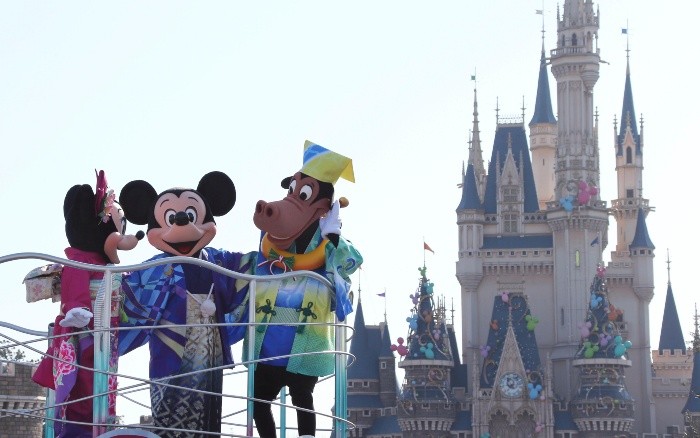FILE - In this Jan. 1, 2014 file photo, Mickey Mouse, center, Minnie Mouse, left, and Horace Horsecollar, all clad in Japan's traditional kimono, entertain visitors to the Tokyo Disneyland during the New Year's celebration at the amusement park in Urayasu, east of Tokyo. Walt Disney Japan apologized Monday, Aug. 10, 2015 after a tweet sent from its corporate Twitter account wished readers 