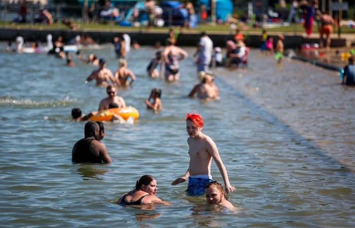 People try to beat the heat at a beach in Chestermere, Alta., Tuesday, June 29, 2021. Environment Canada warns the torrid heat wave that has settled over much of Western Canada won't lift for days. (Jeff McIntosh/The Canadian Press via AP)-MANDATORY CREDIT